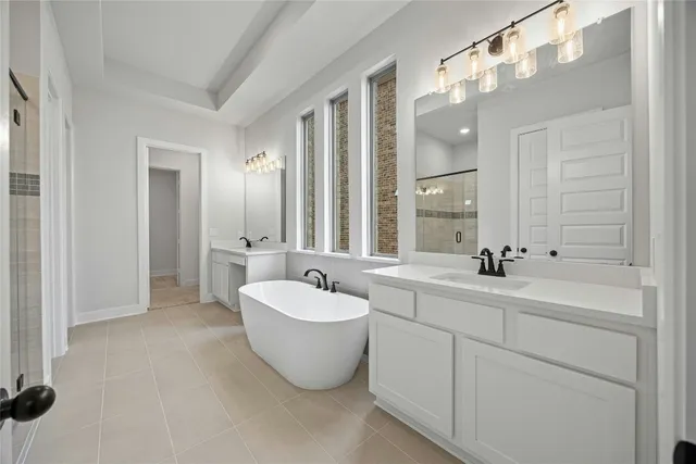 a spacious bathroom with a double vanity sink mirror and bathtub