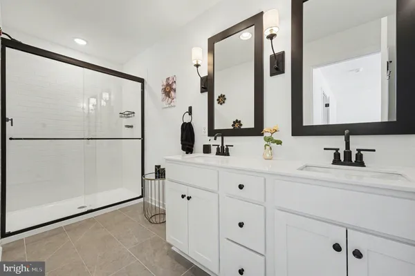 a bathroom with a double vanity sink and mirror