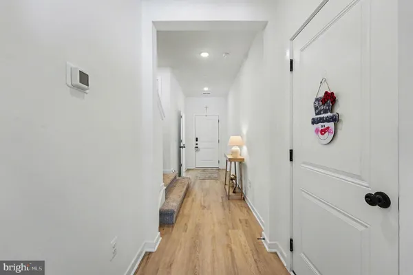 a view of a bathroom with a sink and wooden floor