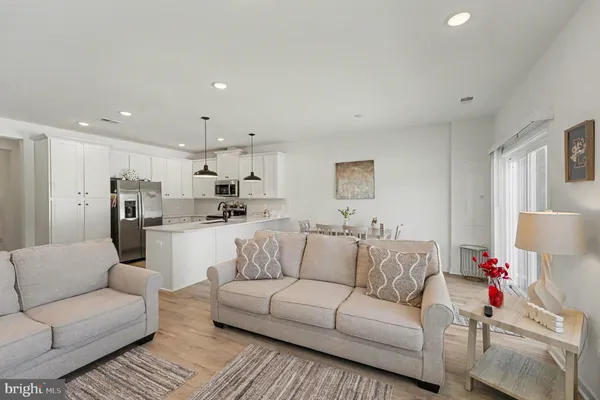 a living room with furniture and kitchen view
