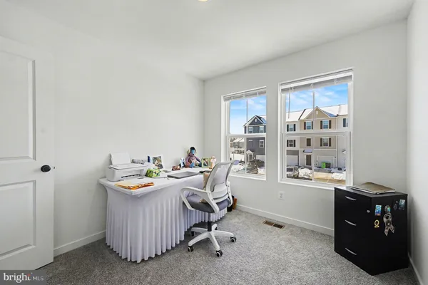 a living room with furniture a window and a bookshelf