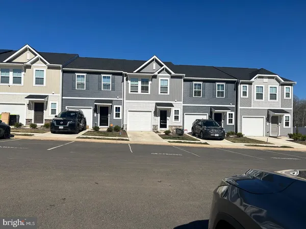 a view of multiple houses with a street