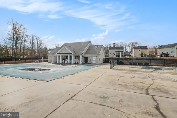 a aerial view of a house next to a big yard and large trees