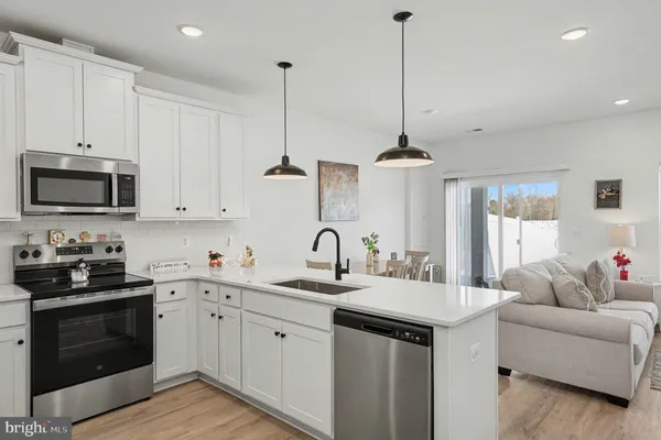 a kitchen with a sink stove and microwave