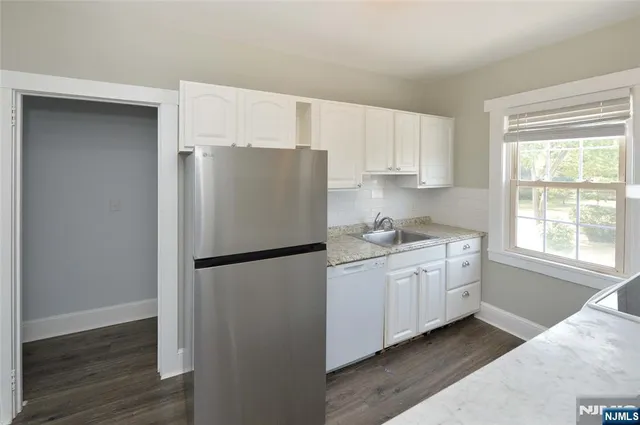 a white refrigerator freezer sitting in a kitchen