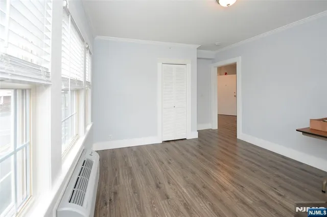 a view of a room with wooden floor and window