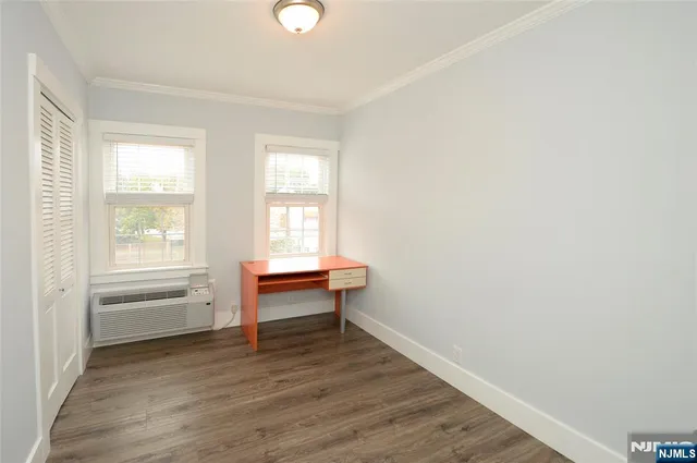 a view of a room with wooden floor cabinets and outdoor view