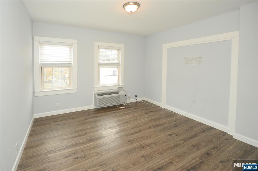 7 Main Street, Unit 2B Glen Rock, NJ 07452 - Photo 15 of 17 an empty room with wooden floor and windows