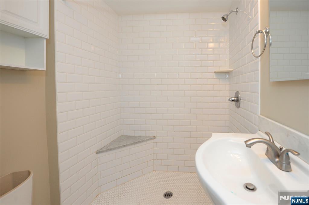 7 Main Street, Unit 2B Glen Rock, NJ 07452 - Photo 16 of 17 a bathroom with a sink and shower