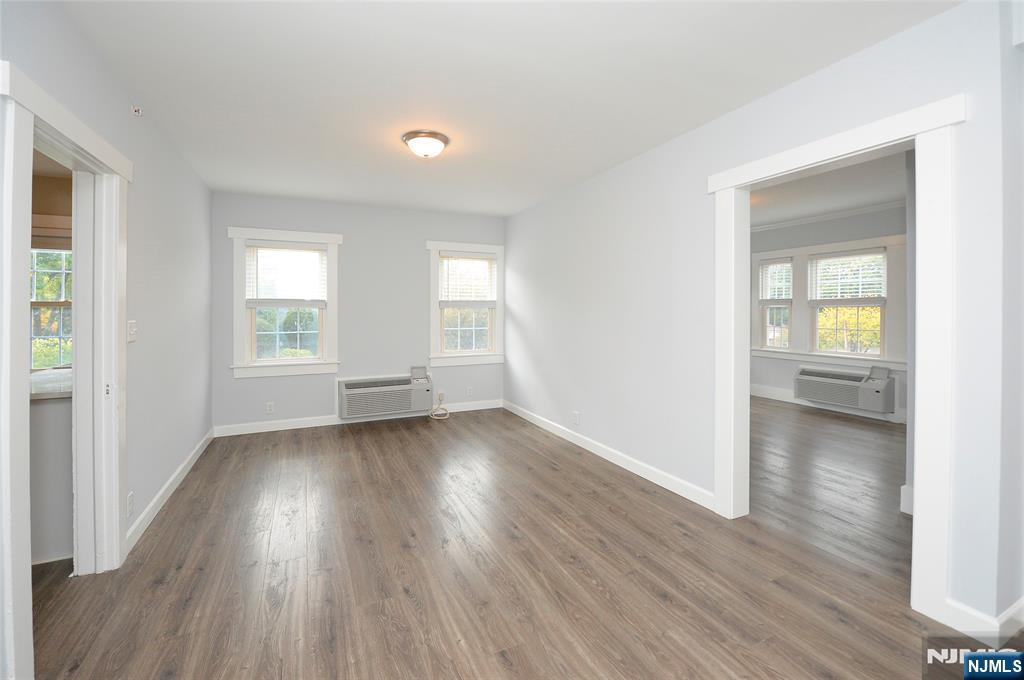 7 Main Street, Unit 2B Glen Rock, NJ 07452 - Photo 6 of 17 an empty room with wooden floor and windows