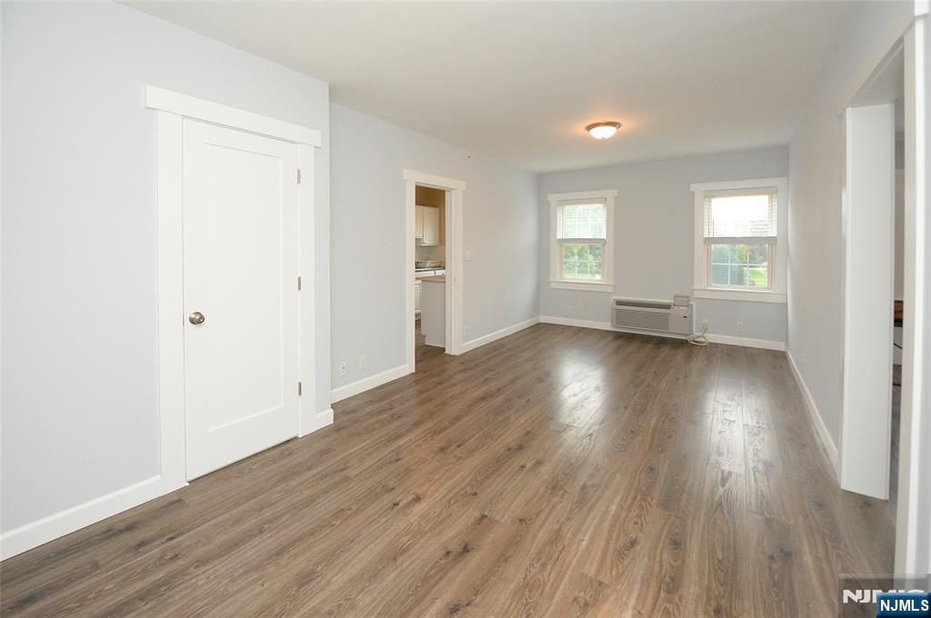 7 Main Street, Unit 2B Glen Rock, NJ 07452 - Photo 7 of 17 an empty room with wooden floor and windows