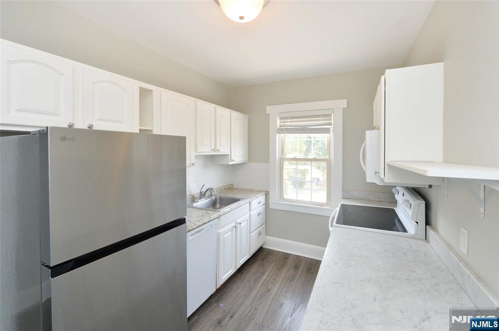 7 Main Street, Unit 2B Glen Rock, NJ 07452 - Photo 10 of 17 a kitchen with granite countertop white cabinets and white appliances