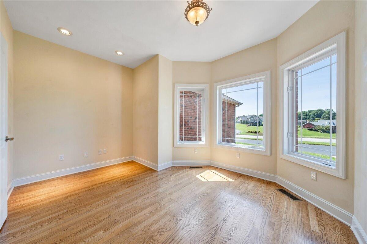 625 Frontier Way Fincastle, VA 24090 - Photo 32 of 105 a view of an empty room with wooden floor and a window