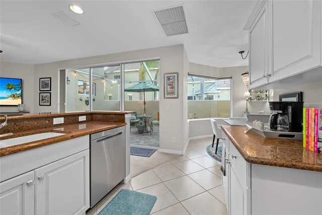 a kitchen with granite countertop a sink and a stove