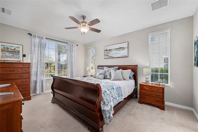 a spacious bedroom with a bed and a window