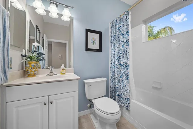 a bathroom with a sink a toilet and shower curtain