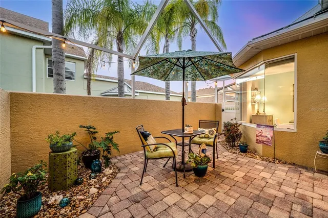 a view of a patio with table and chairs under an umbrella