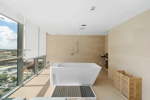 a room with pool table and windows