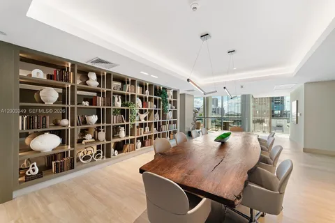 a living room with couches and kitchen view