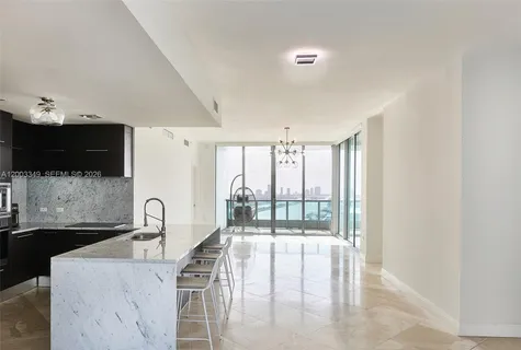 a kitchen with a sink and a large window