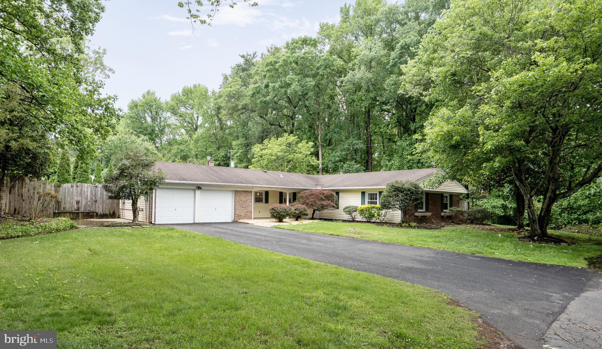 13030 Maple View Lane Fairfax, VA 22033 - Photo 1 of 30 a front view of a house with a yard and trees