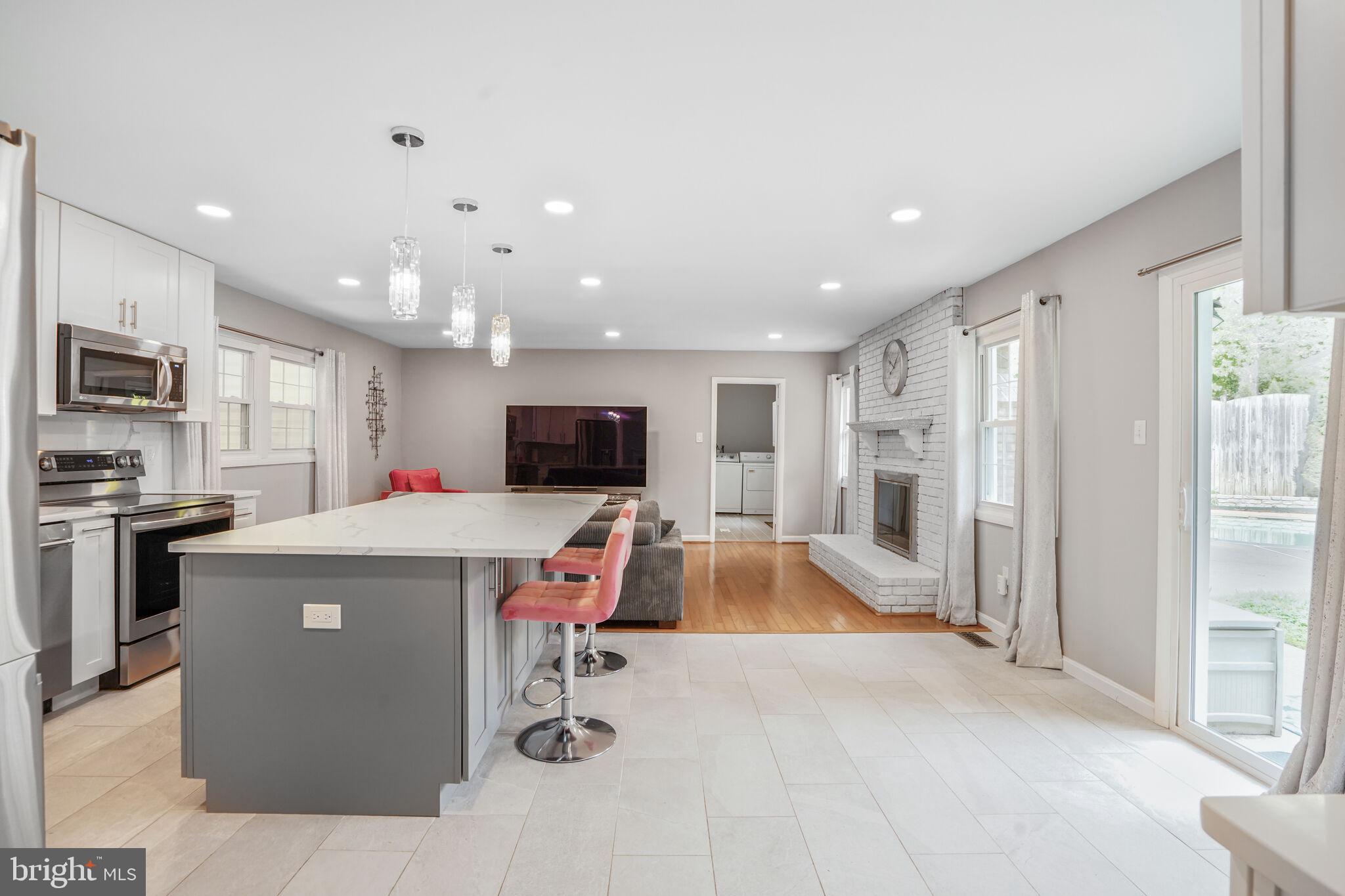 13030 Maple View Lane Fairfax, VA 22033 - Photo 11 of 30 a living room with stainless steel appliances furniture a flat screen tv and a kitchen view