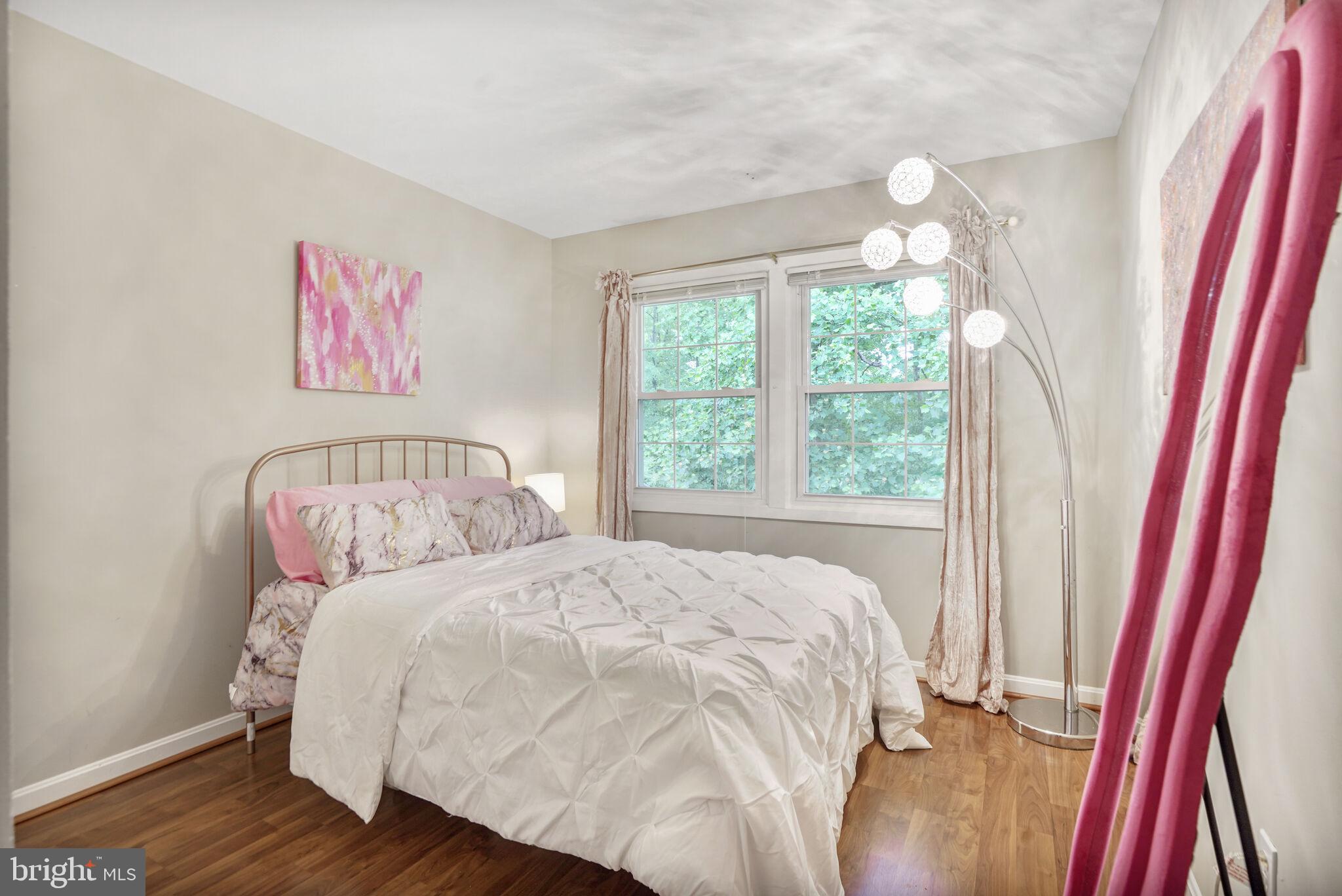 13030 Maple View Lane Fairfax, VA 22033 - Photo 16 of 30 a bedroom with a bed and a painting on the wall