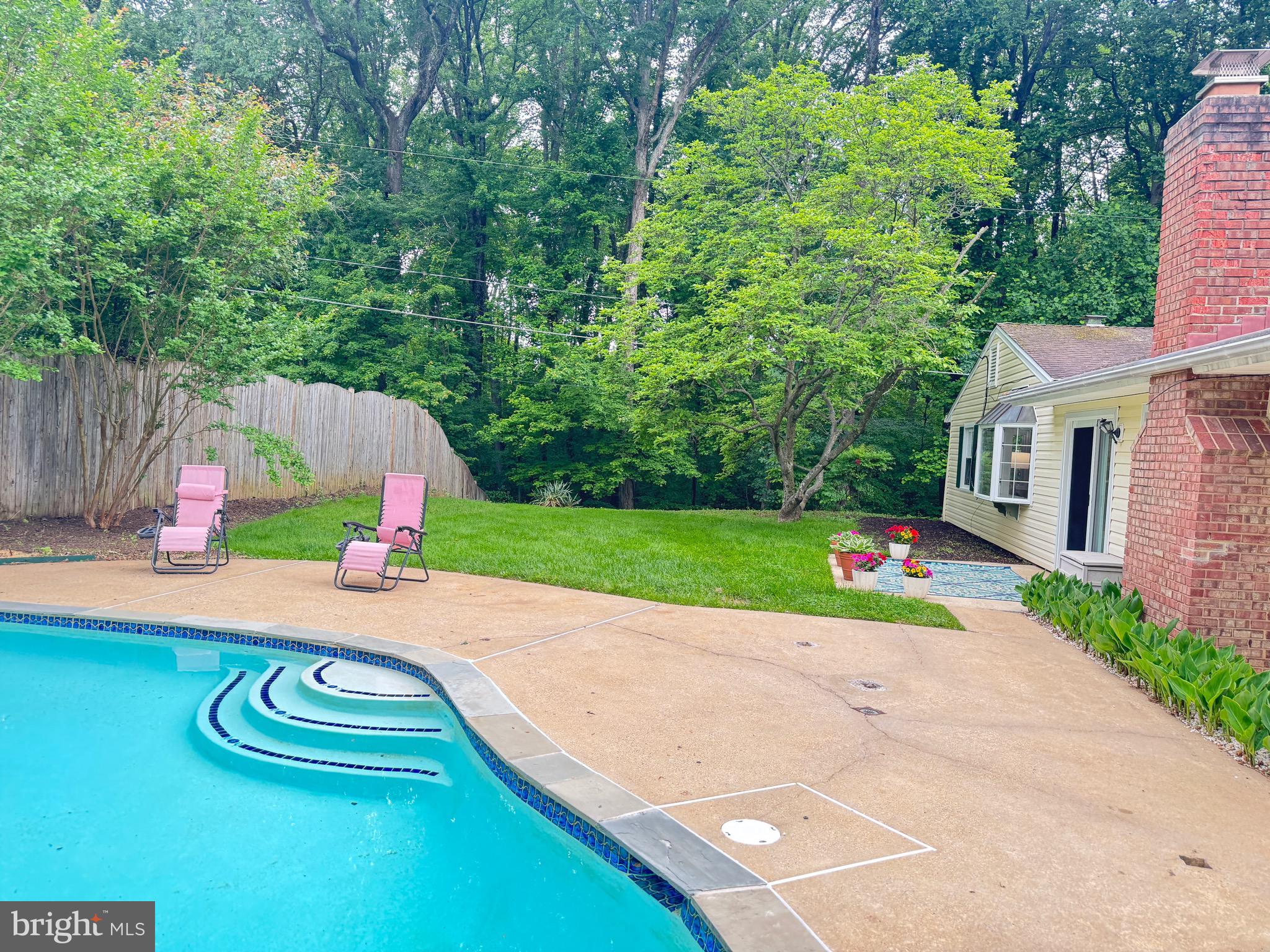 13030 Maple View Lane Fairfax, VA 22033 - Photo 21 of 30 a view of a backyard with table and chairs and potted plants