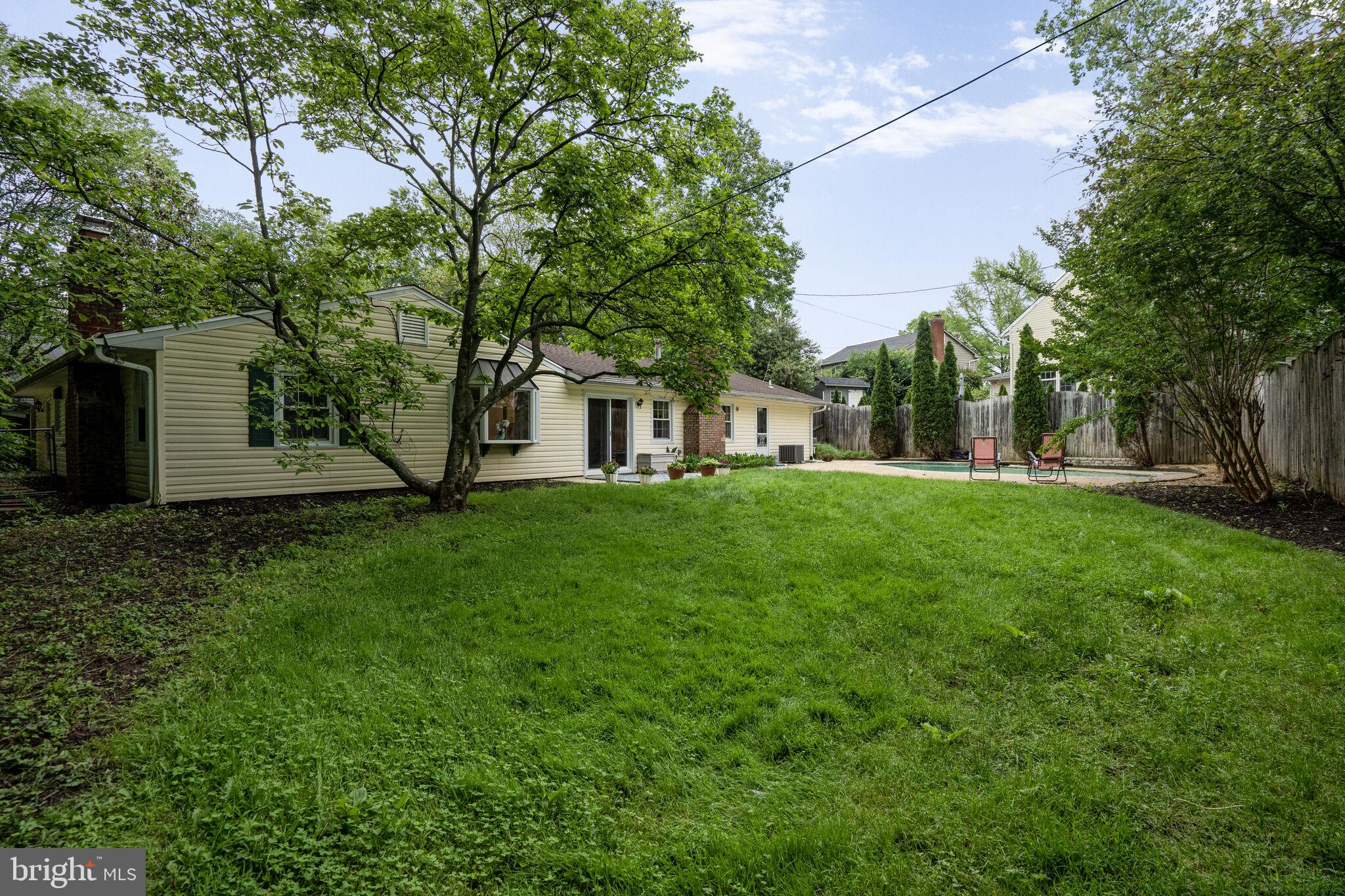 13030 Maple View Lane Fairfax, VA 22033 - Photo 23 of 30 a view of a white house with a big yard and large trees