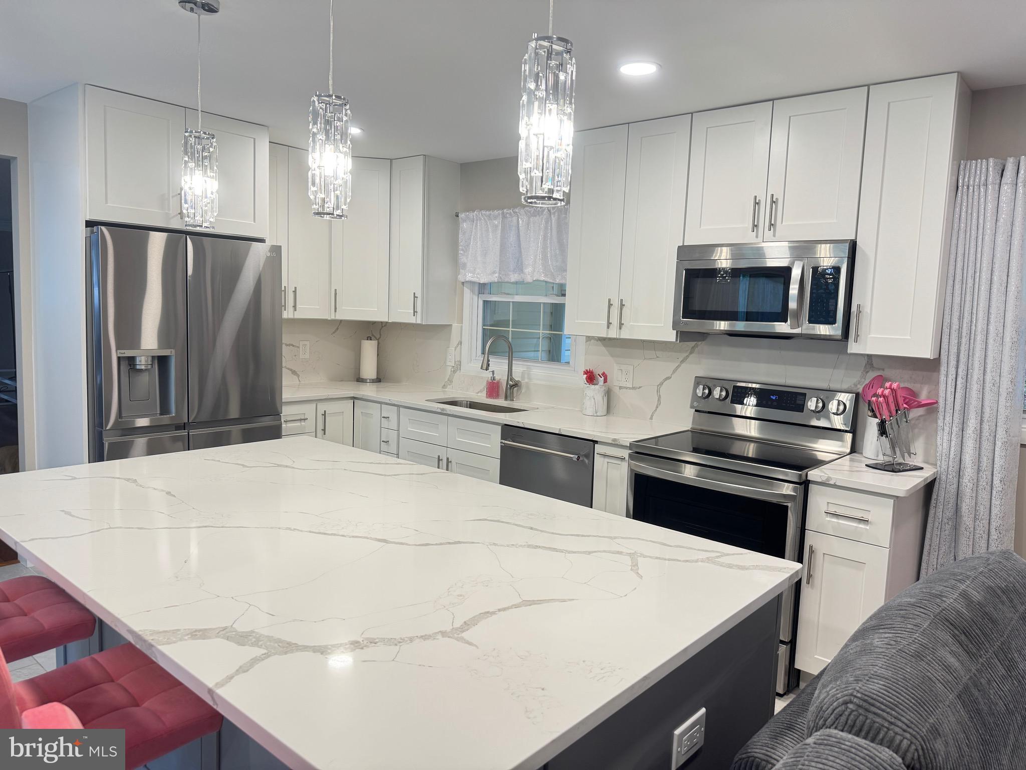 13030 Maple View Lane Fairfax, VA 22033 - Photo 29 of 30 a kitchen with kitchen island a sink stainless steel appliances and cabinets