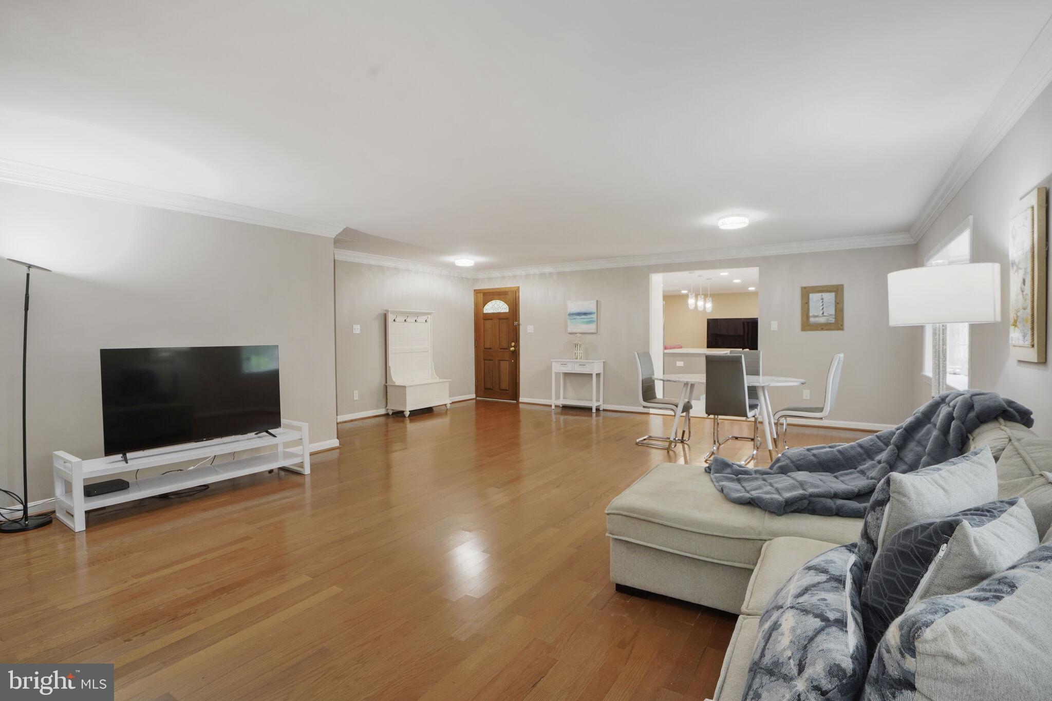 13030 Maple View Lane Fairfax, VA 22033 - Photo 3 of 30 a living room with furniture and a flat screen tv