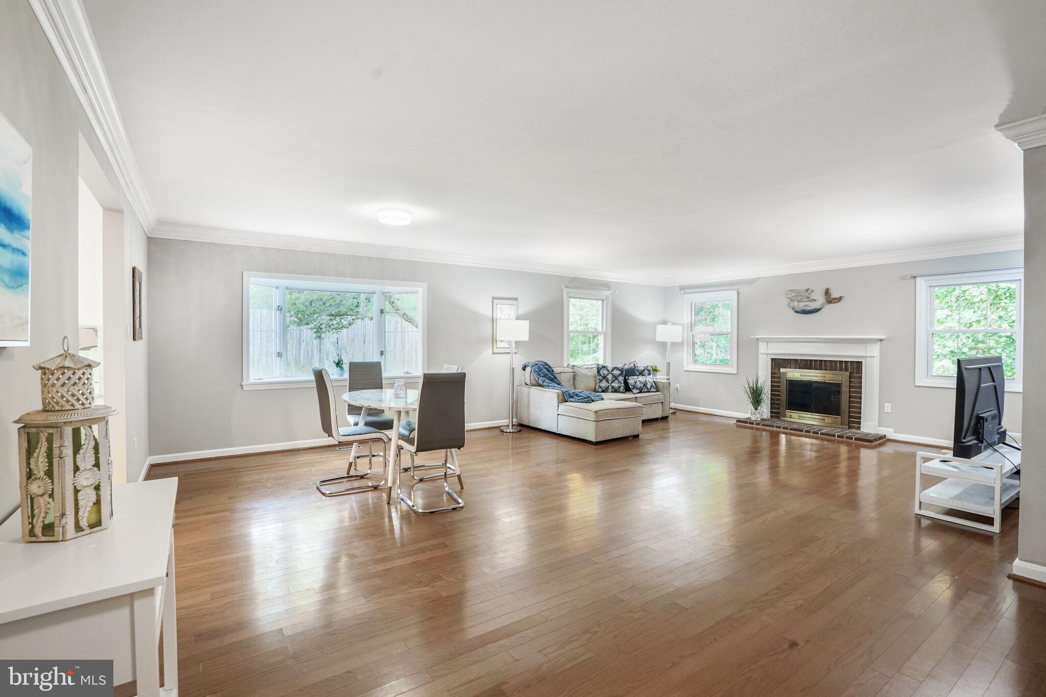 13030 Maple View Lane Fairfax, VA 22033 - Photo 6 of 30 a living room with furniture a fireplace and a table