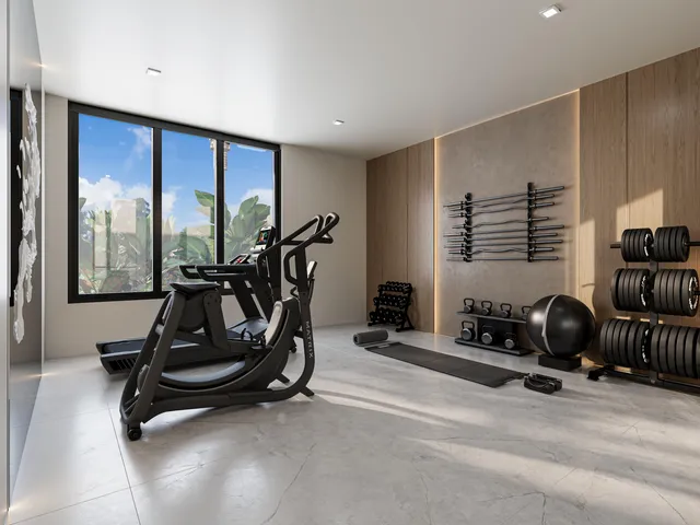 a room with gym equipment and large mirror