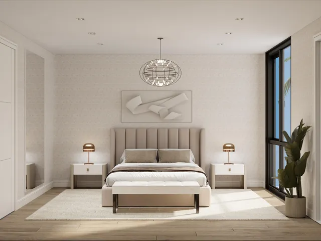 a bedroom with a large bed and a chandelier