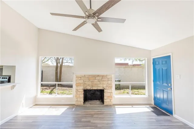a living room with a fireplace and a floor to ceiling window