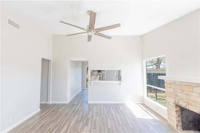 a view of a livingroom with wooden floor and an empty space