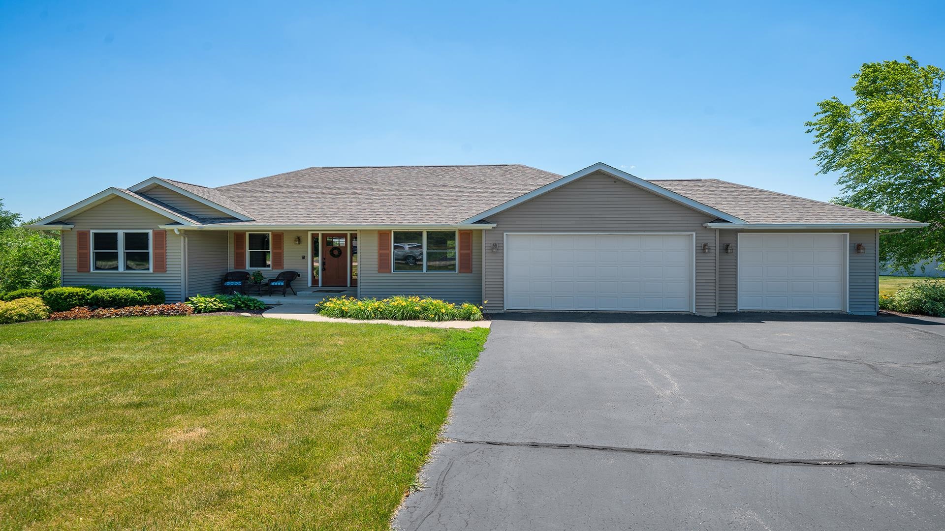 a front view of a house with a yard and garage