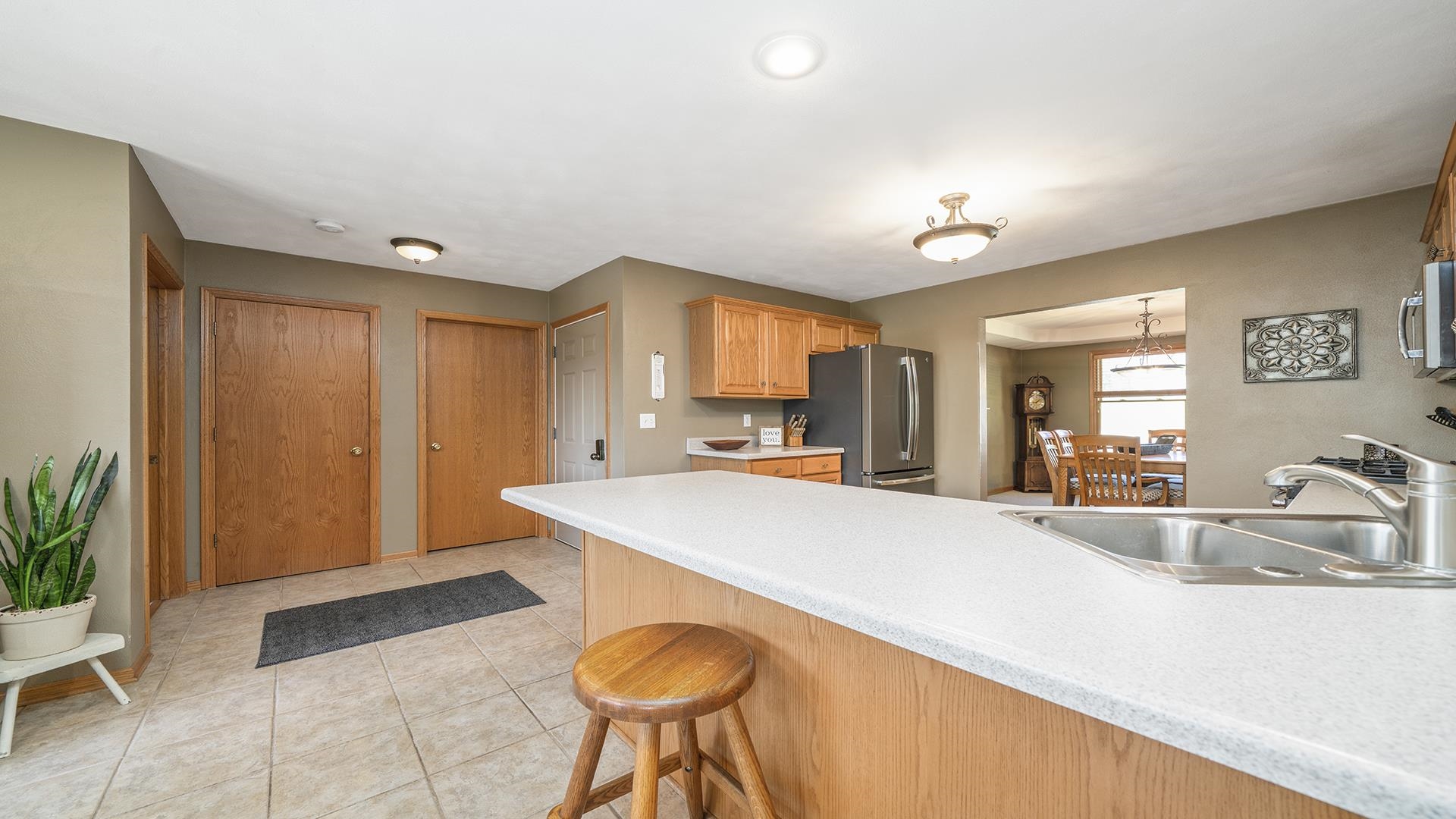 4317 Ridgeview Lane Byron, IL 61010 - Photo 12 of 41 a view of a kitchen with kitchen island a sink wooden floor and a refrigerator