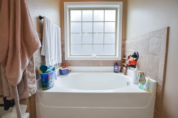 a white bath tub sitting next to a window