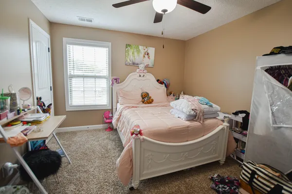 a bed room with a bed and a chair