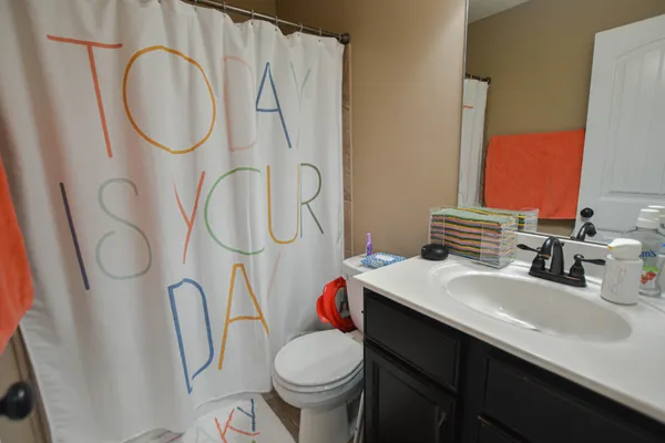 a bathroom with a sink toilet and a mirror