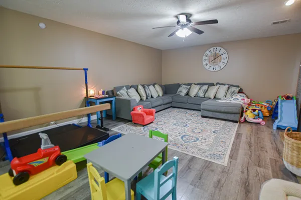 a living room with furniture and wooden floor