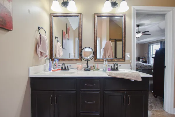 a bathroom with a double vanity sink and a mirror
