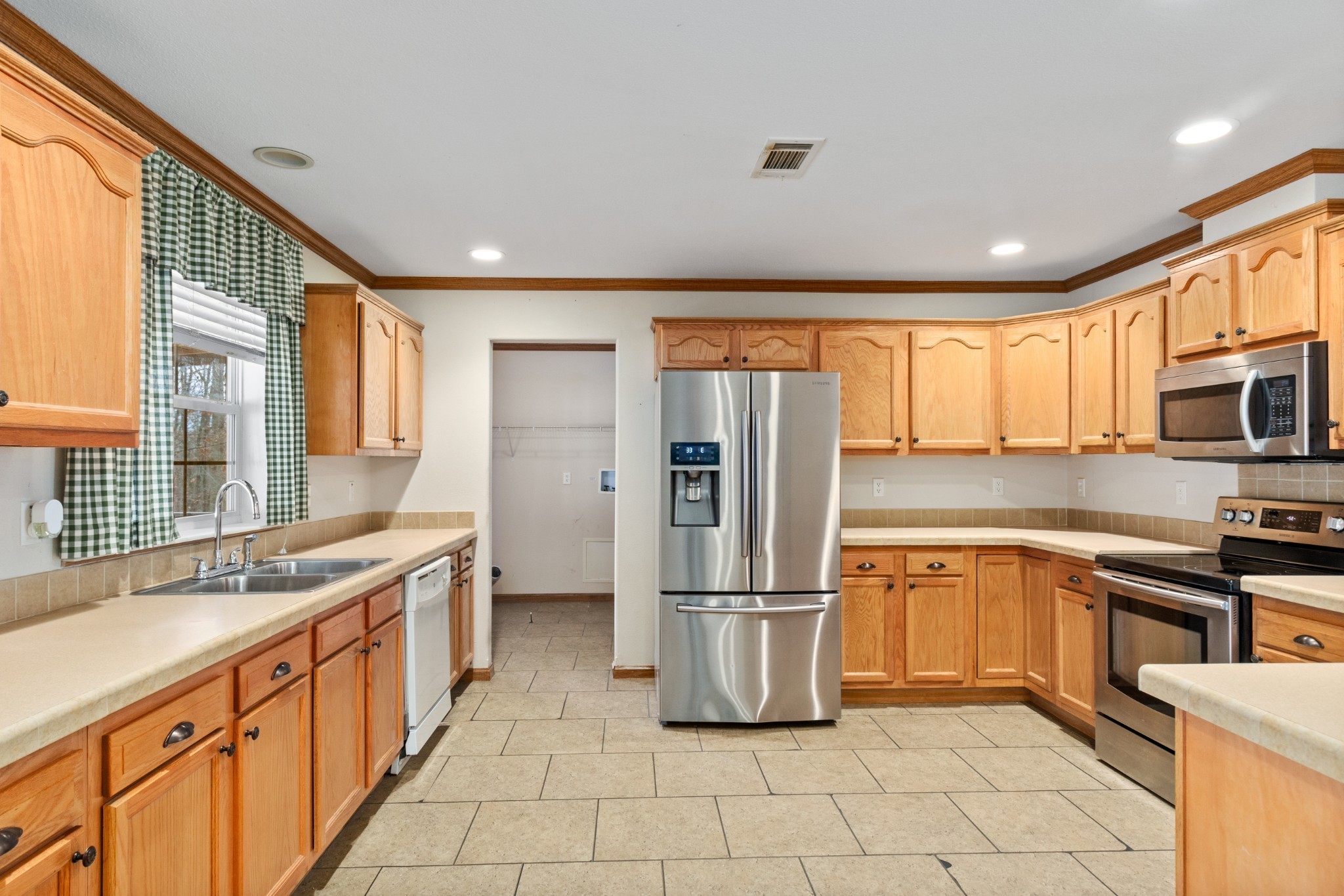 5147 Spears Road Centerville, TN 37033 - Photo 17 of 40 a kitchen with stainless steel appliances granite countertop a refrigerator and a sink