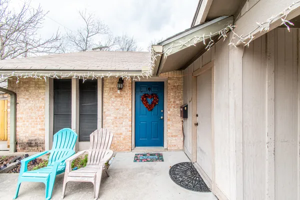 a view of a wooden door and outdoor seating
