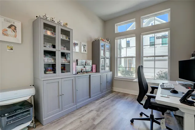 a view of a workspace with furniture and a window