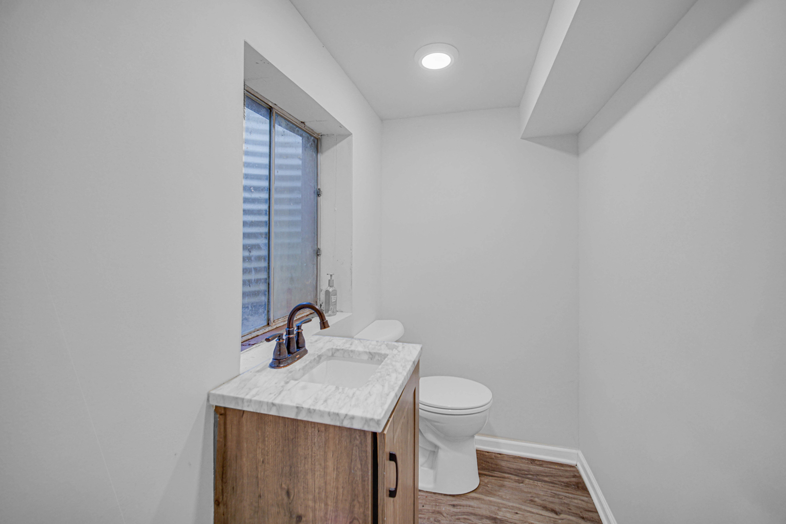 933 Shambliss Lane Buffalo Grove, IL 60089 - Photo 11 of 29 a bathroom with a sink a toilet and mirror