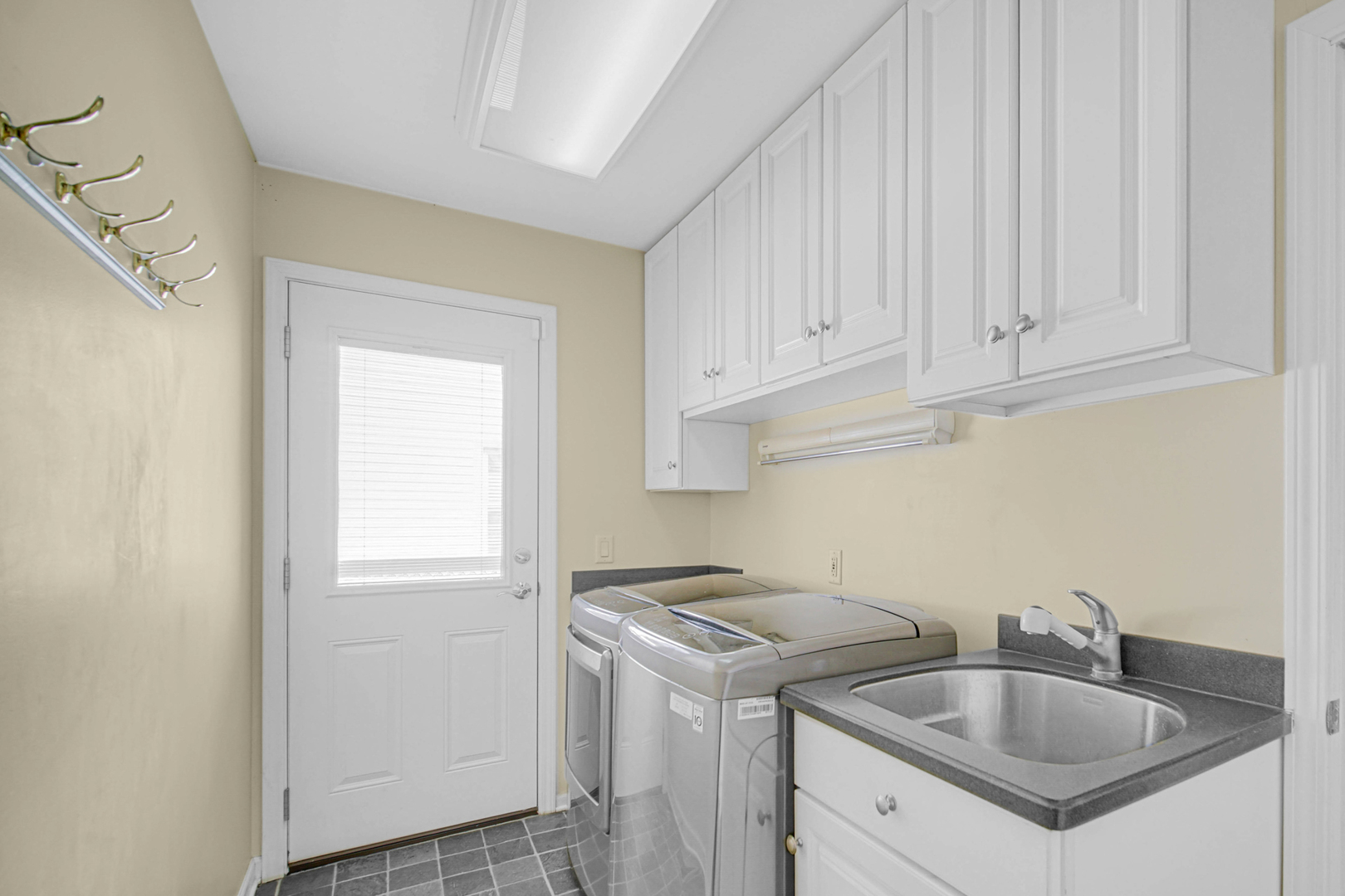 933 Shambliss Lane Buffalo Grove, IL 60089 - Photo 14 of 29 a kitchen with stainless steel appliances granite countertop a sink stove and cabinets