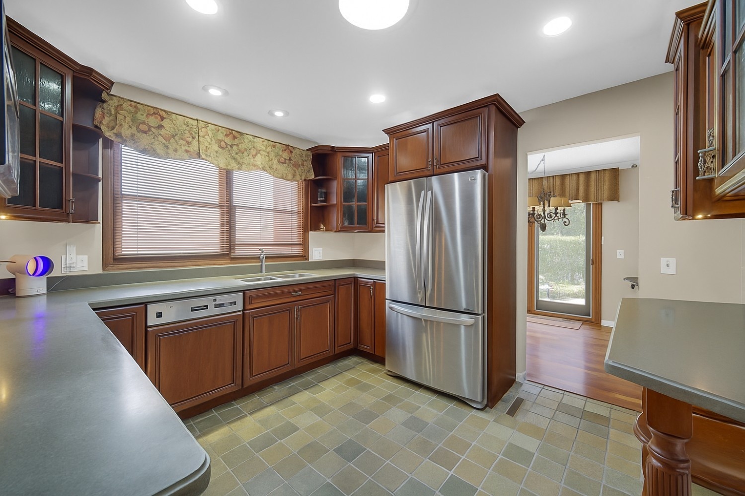 933 Shambliss Lane Buffalo Grove, IL 60089 - Photo 15 of 29 a kitchen with stainless steel appliances granite countertop a refrigerator and a stove top oven