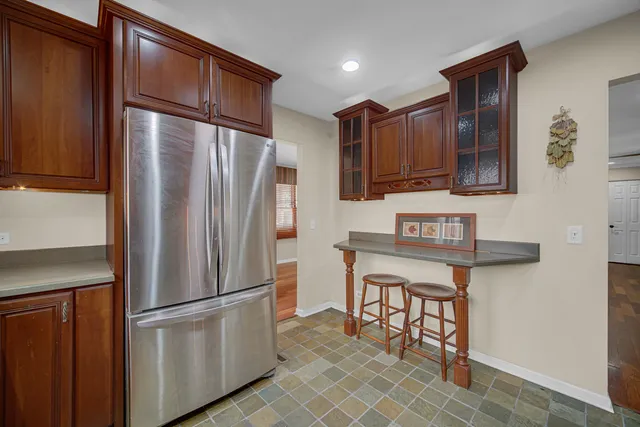 a kitchen with stainless steel appliances granite countertop a refrigerator and a stove top oven
